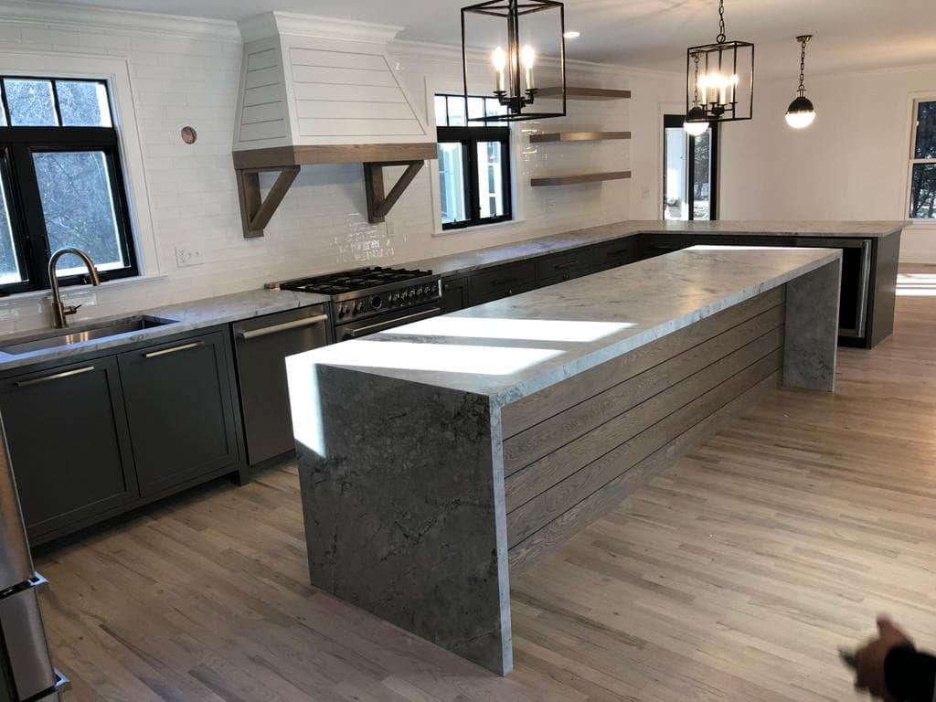Quartzite and marble countertop slabs seen side by side