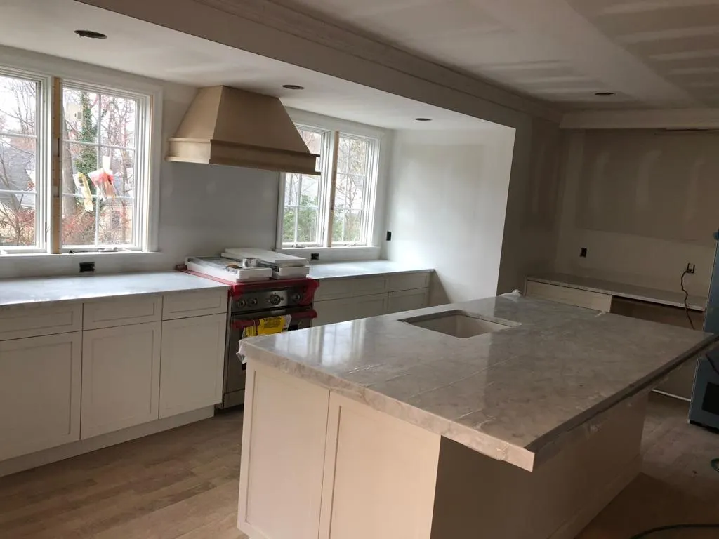 Kitchen peninsula with light granite countertops